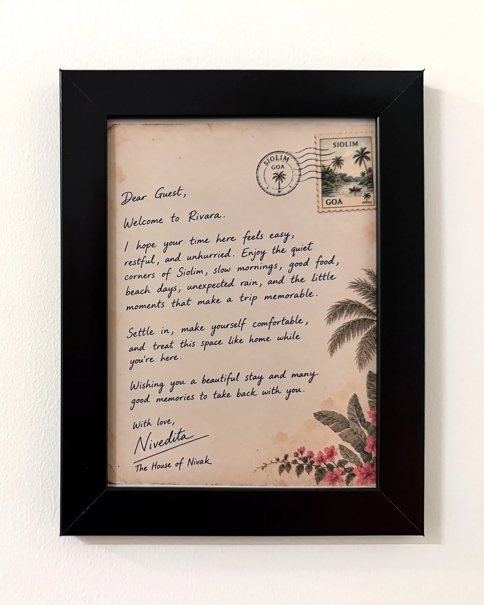 A handwritten welcome note from Nivedita, framed in the hallway