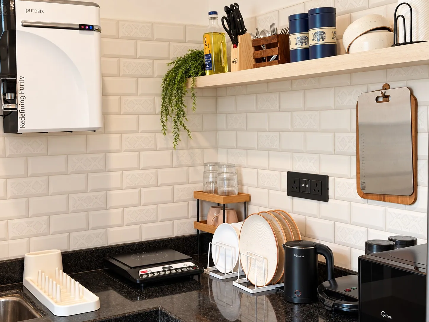 The kitchen corner with the RO water purifier, an open shelf and the induction cooktop