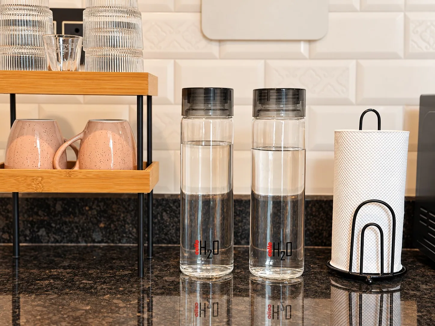 Glass water bottles, mugs and glassware on the counter